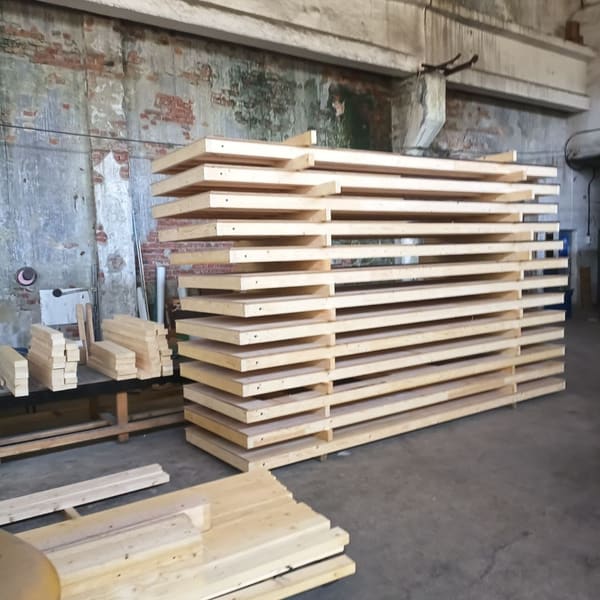 A tall stack of finished glulam ring segments in the workshop